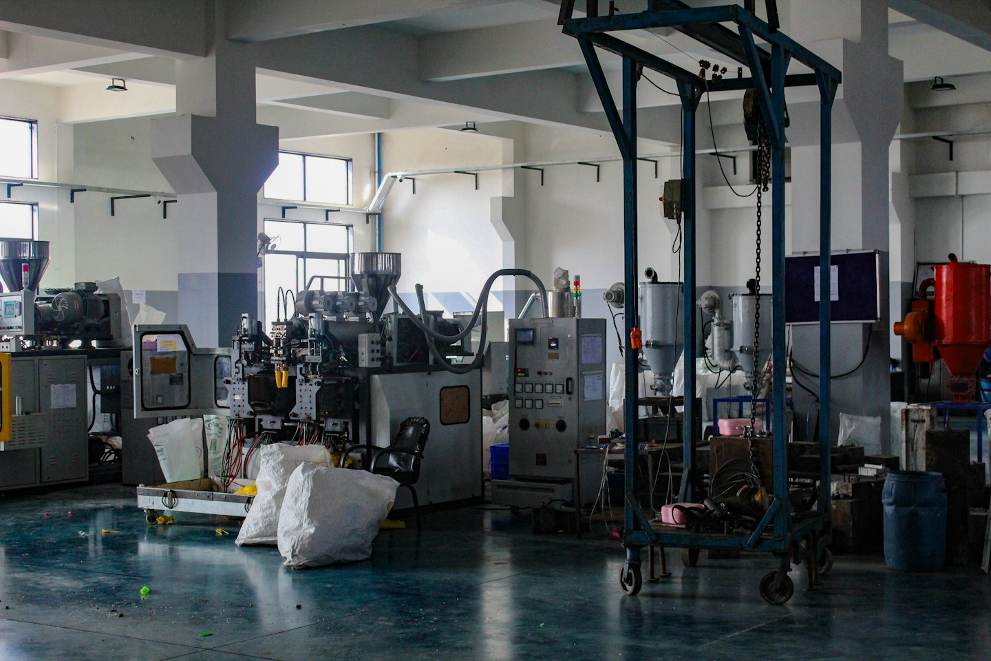Modern manufacturing facility with plastic processing equipment.